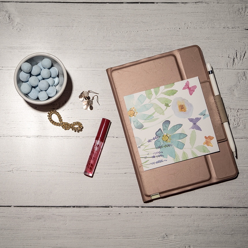 Self love at Easter - Flat lay of iPad, sweets and lip gloss