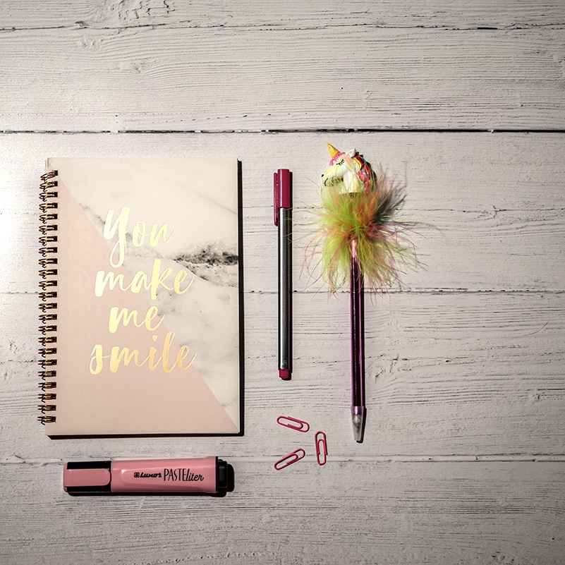 Tapping Solution - notepad and pens on a wooden table