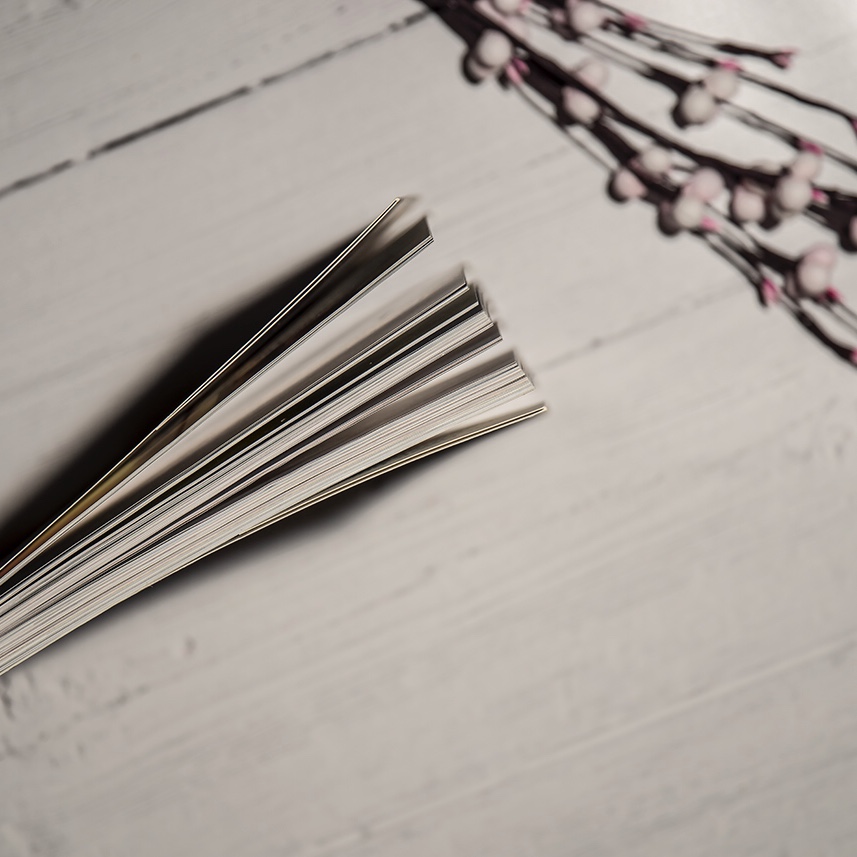 Surround yourself with positivity - image shows a flatlay with dry flowers and a book end